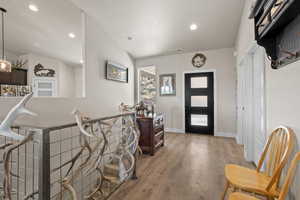 Foyer with lofted ceiling and hardwood / wood-style floors