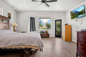 Bedroom featuring access to exterior, ceiling fan, and light hardwood / wood-style flooring