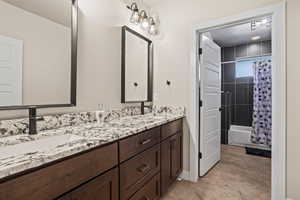 Bathroom featuring vanity and shower / bath combo