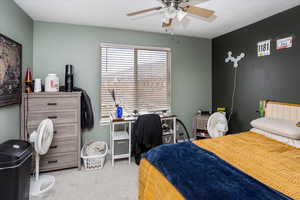 Bedroom featuring ceiling fan and light carpet