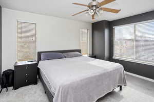 Bedroom featuring light colored carpet and ceiling fan