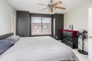 Bedroom featuring light colored carpet and ceiling fan