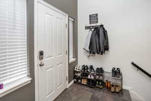 Mudroom featuring dark tile patterned floors