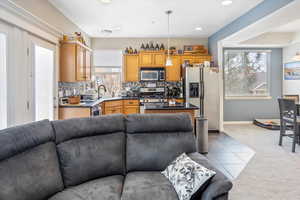 Kitchen with plenty of natural light, appliances with stainless steel finishes, sink, and backsplash