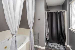 Bathroom with tile patterned floors and separate shower and tub