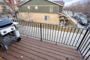 Wooden deck with a mountain view and a grill