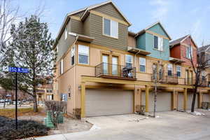 View of property featuring a garage and a balcony