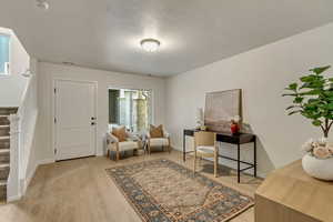 Interior space featuring light hardwood / wood-style floors and a textured ceiling