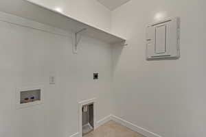 Laundry room featuring light tile patterned flooring, washer hookup, and electric dryer hookup