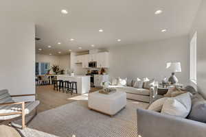 Living room with sink and light wood-type flooring