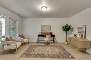 Interior space featuring light hardwood / wood-style flooring and a textured ceiling