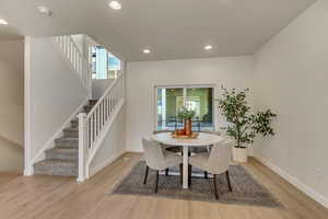 Dining space with light hardwood / wood-style floors