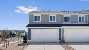 Front of property featuring a garage and central air condition unit