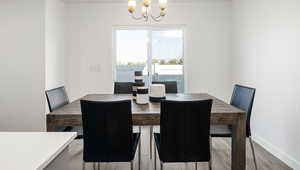 Dining room with an inviting chandelier and light hardwood / wood-style floors