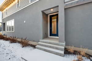 View of snow covered property entrance