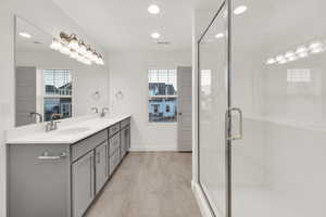 Bathroom with vanity and a shower with shower door