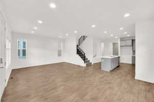 Unfurnished living room featuring light hardwood / wood-style floors and sink