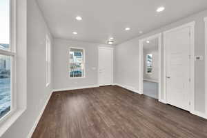 Empty room featuring dark wood-type flooring