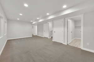 Basement with light colored carpet