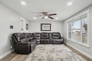 Living room with hardwood / wood-style floors and ceiling fan