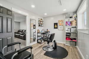 Exercise area featuring light hardwood / wood-style flooring