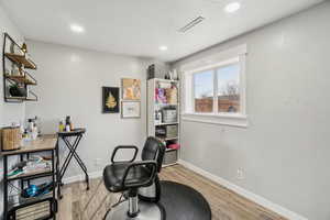 Office with a textured ceiling and light wood-type flooring