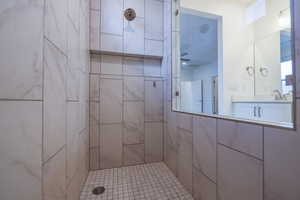 Bathroom with vanity and a tile shower