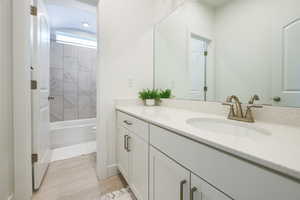 Full bathroom featuring toilet, hardwood / wood-style flooring, vanity, and tiled shower / bath