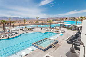 View of pool with a mountain view, a patio area, and a community hot tub