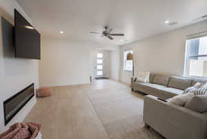 Living room featuring ceiling fan and light hardwood / wood-style floors