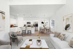 Living room with a chandelier and light hardwood / wood-style flooring