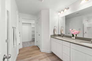 Bathroom featuring vanity, hardwood / wood-style floors, a textured ceiling, and a shower