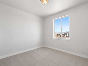 Carpeted empty room with a textured ceiling