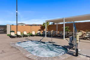 View of pool featuring a hot tub and a patio