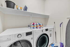 Laundry room featuring cabinets and washing machine and dryer