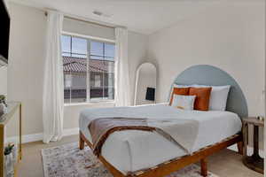 Bedroom featuring light colored carpet