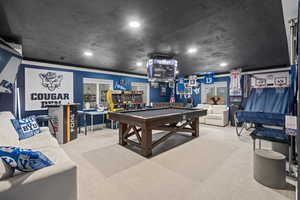 Playroom featuring pool table, ornamental molding, and carpet