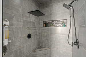 Bathroom featuring tiled shower