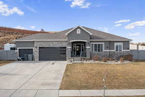 View of front of property featuring a garage and a front yard