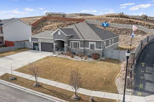 View of front of property with a garage, a mountain view, and a front lawn