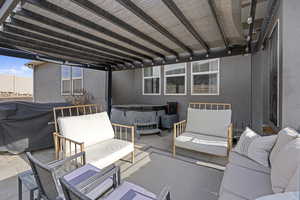 View of patio / terrace with a hot tub and outdoor lounge area