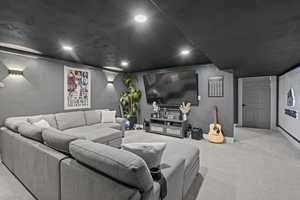 Home theater room with light carpet