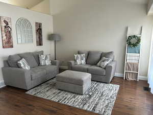 Living room with dark hardwood / wood-style floors