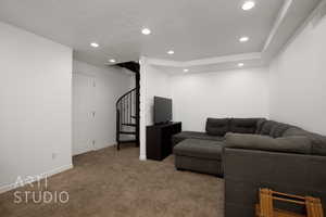 Carpeted living room featuring a textured ceiling