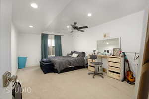 Carpeted bedroom featuring ceiling fan