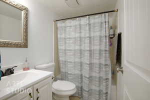 Bathroom with vanity, a textured ceiling, and toilet