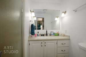 Bathroom featuring vanity and toilet