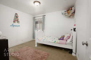 Carpeted bedroom featuring a textured ceiling