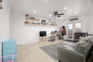 Living room with french doors and ceiling fan