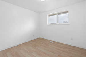 Unfurnished room with light wood-type flooring